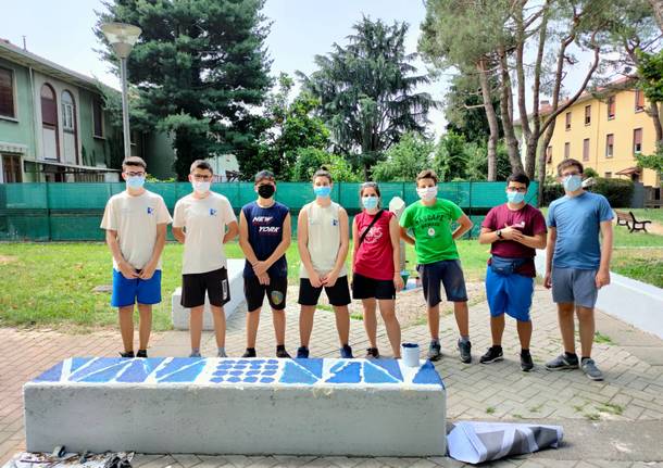 Giovani saronnesi al lavoro per dipingere le panchine del Matteotti 