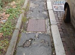 Buche al marciapiede di via Dandolo a Varese